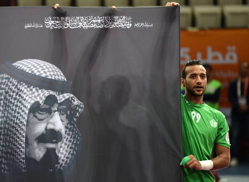 Il saudita Abbas al-Saffar espone una bandiera in onore del re Abdullah scomparso ieri (Afp) 